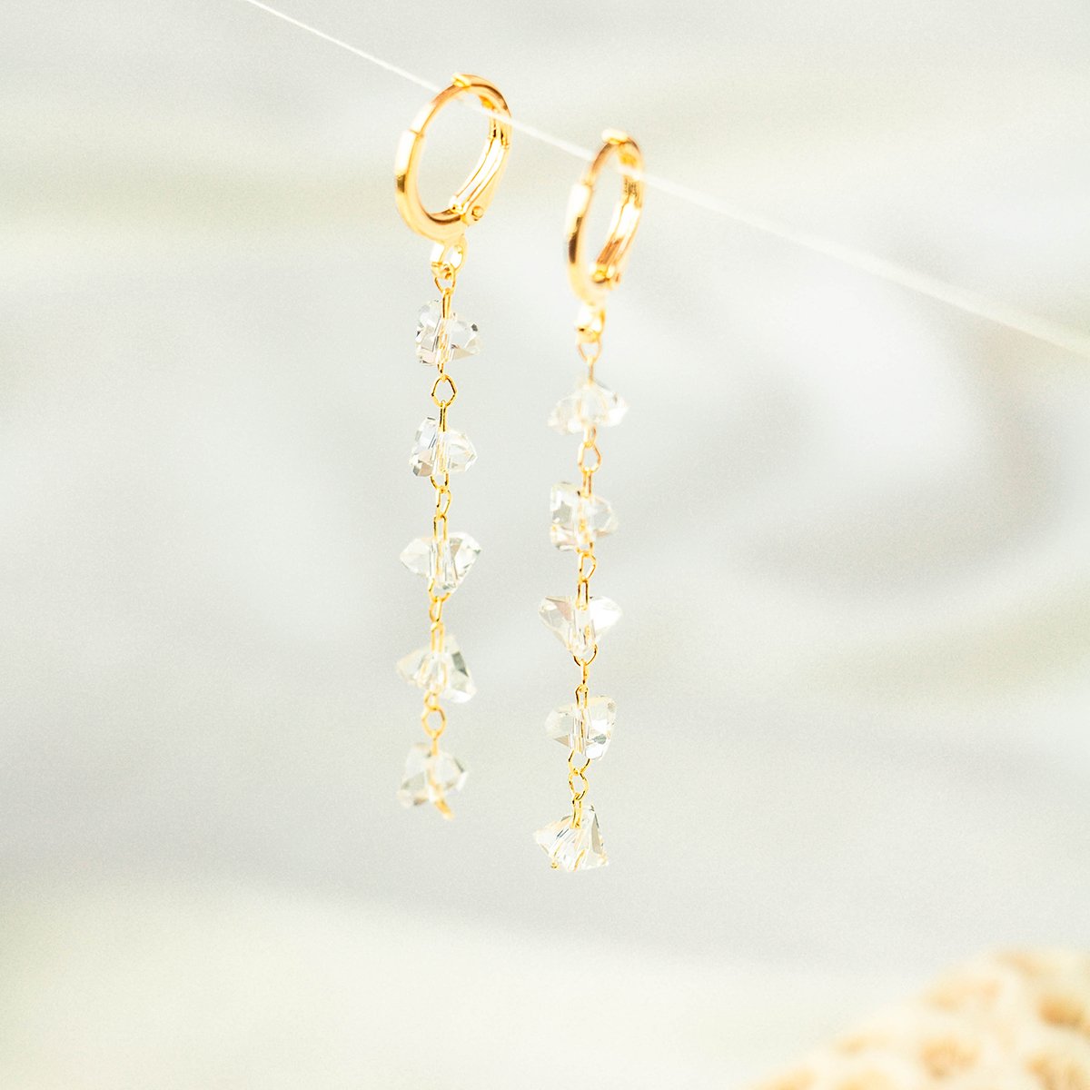 Brinco de argola com zircônias transparentes lapidadas em triângulo folheado a ouro 18k
