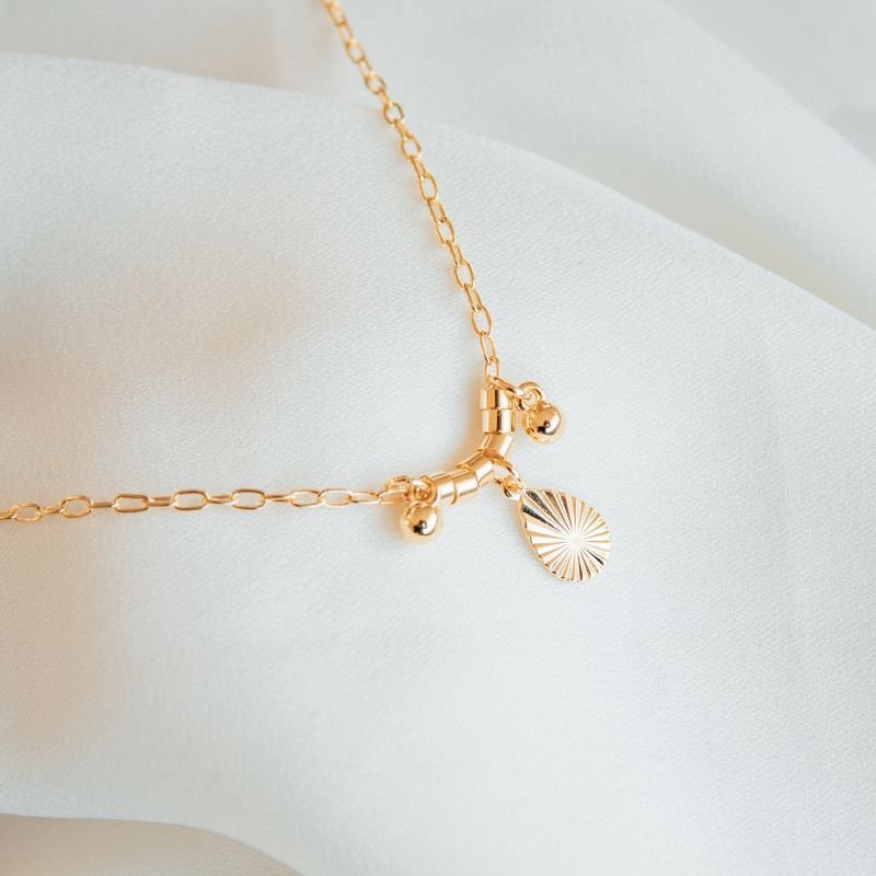 Pulseira gota raiada com esferas folheada a ouro 18k